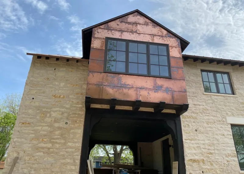 Copper metal panel facade on a stone building for Roof Repair in Lewisville
